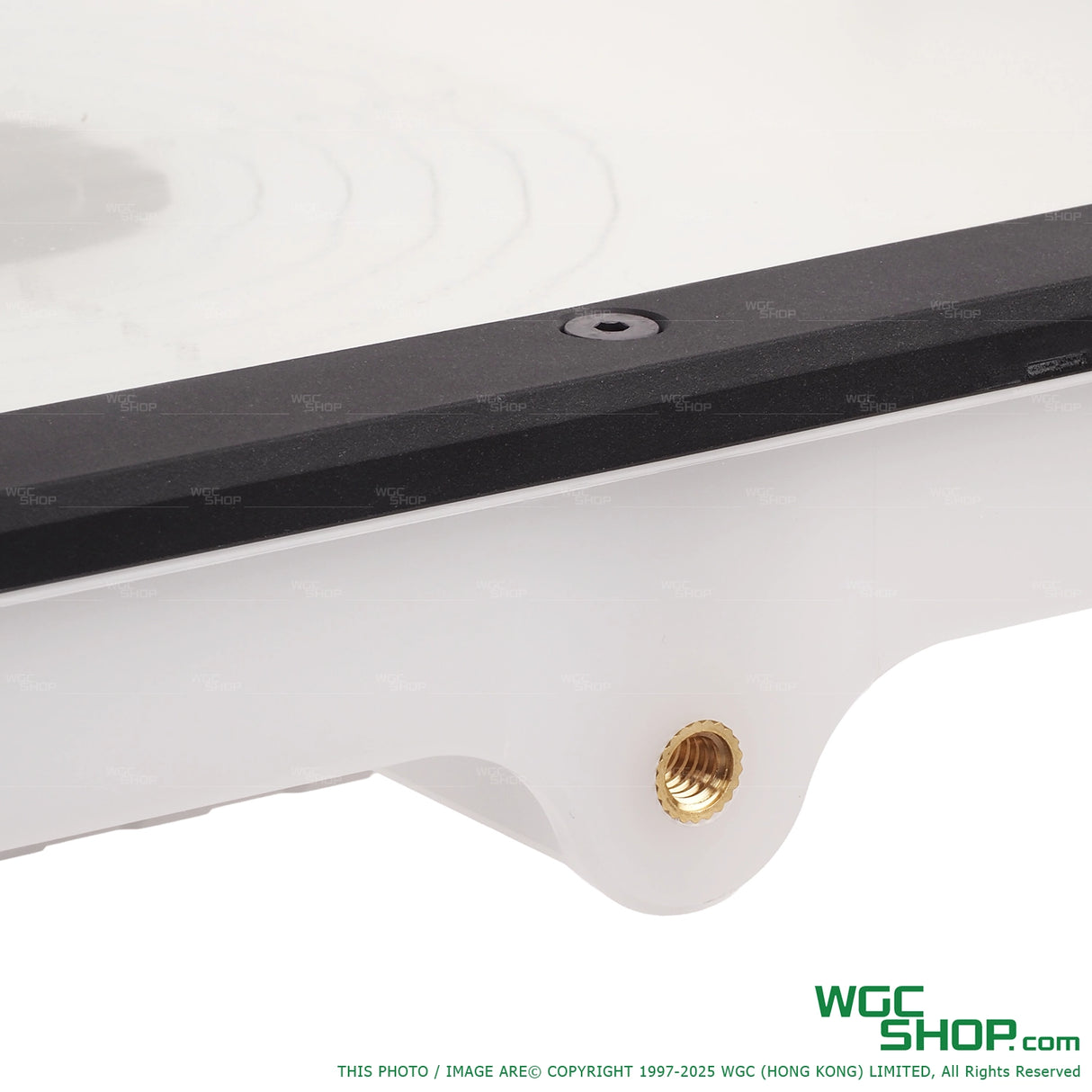 Close-up of a white and black Acetech Alignmentor part with a brass threaded insert