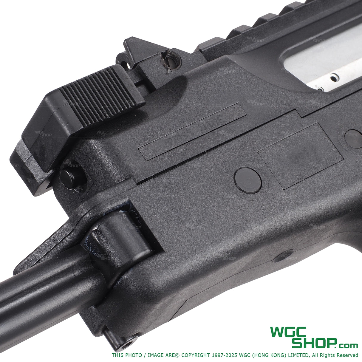 Close-up of black polymer firearm lower receiver with charging handle and trigger group details