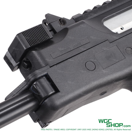 Close-up of black polymer firearm lower receiver with charging handle and trigger group details