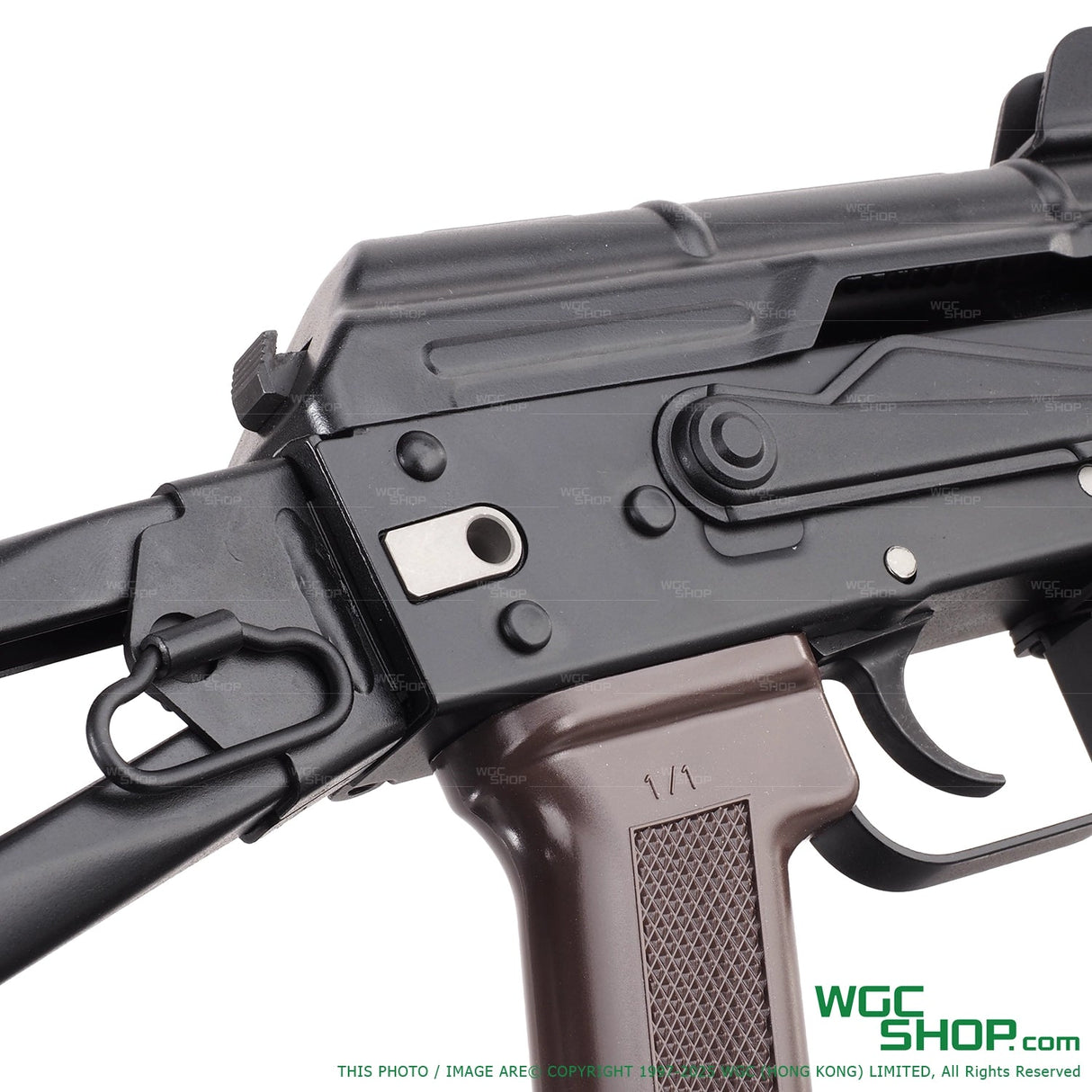 Close-up of VFC AKS74U airsoft rifle with black metal and brown grip details